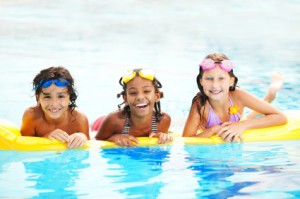 Smiling children in pool.